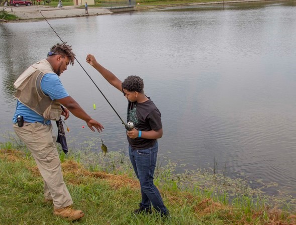 Staff helps boy fish