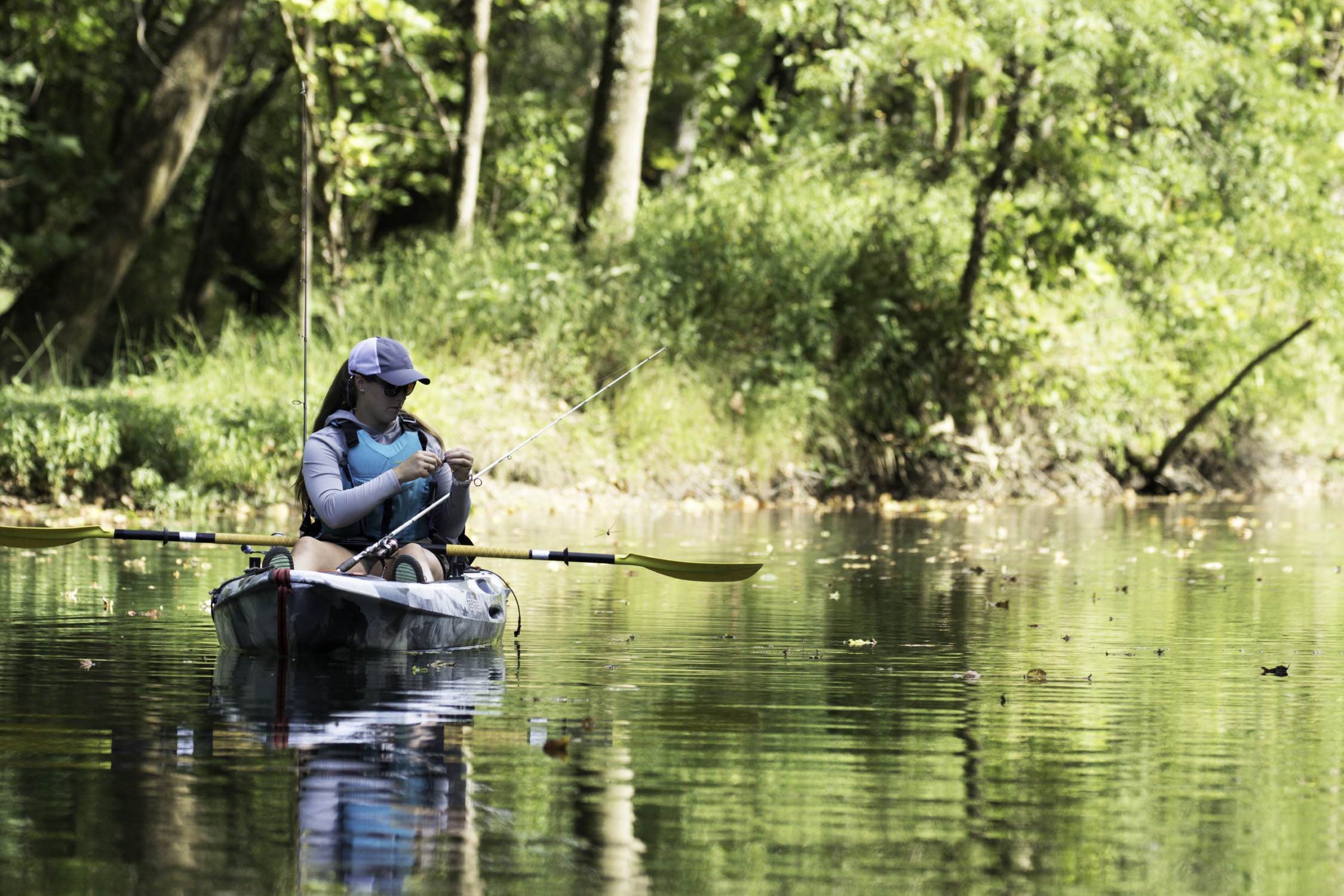 woman fishing from kayak