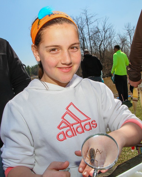 A young student shows off an insect that landed on her hand.