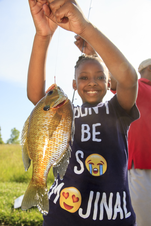 Young angler shows off her catch.