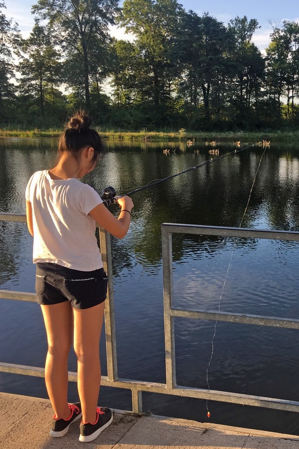 girl fishing from dock