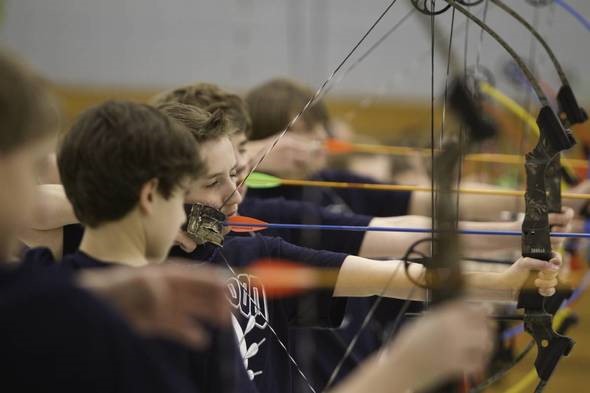 student archers taking aim during archery practice