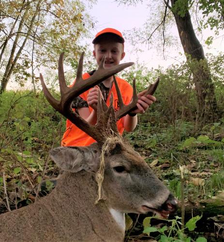Lucas Gruber holds a buck he harvested in Howard County.