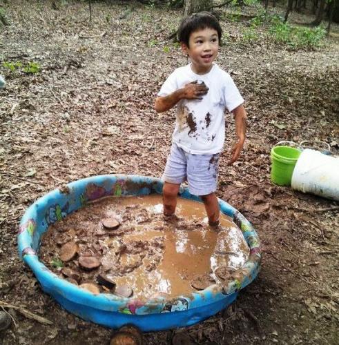 kid in mud pool