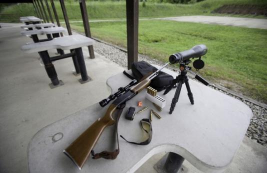 Rifle with sight at shooting range