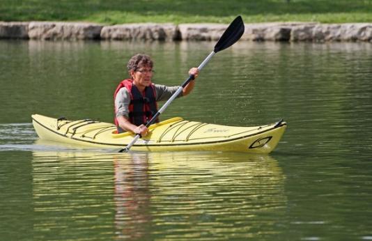 Man kayaks on lake.