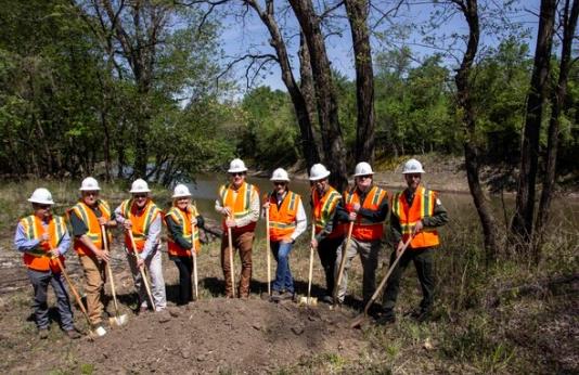 Staff pose for groundbreaking photo for pump station at Schell-Osage 