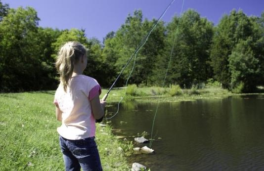 Young girl fishing at lake
