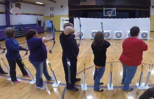 Teachers attending archery instructor training.