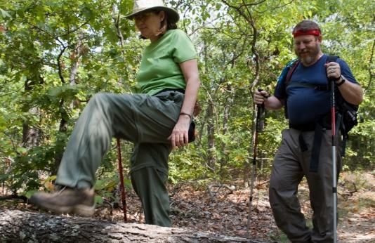 A man and woman test their skills while hiking the Green Rock Trail.