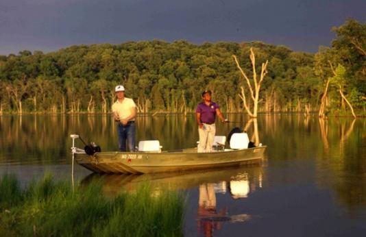 Two people fishing from a boat on Harmony Mission Lake.