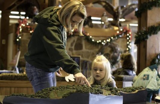 A woman teaches a little girl about nature at Runge Nature Center.
