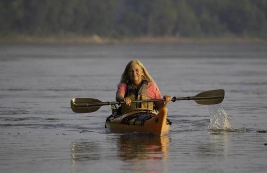 woman paddling a kayak 