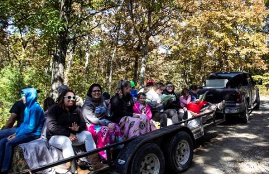 A group of people enjoy fall colors while taking a driving tour through Poosey Conservation Area.