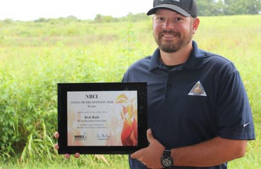 Rick Rath poses with his Firebird Award for quail efforts.