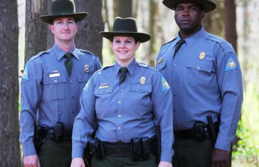 three conservation agents standing