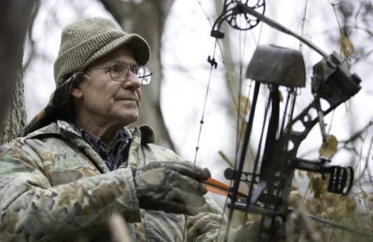 bowhunter in treestand