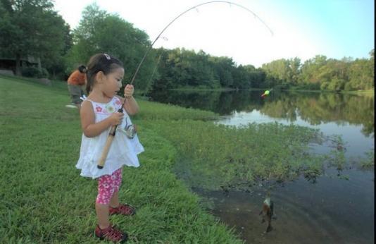 girl fishing in pond