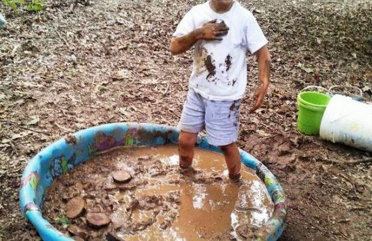 kid in mud pool
