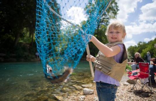 kid with fish in net
