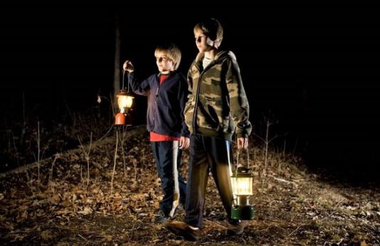 Two boys take a night hike with lanterns