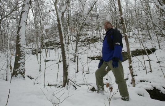 man on winter hike in woods