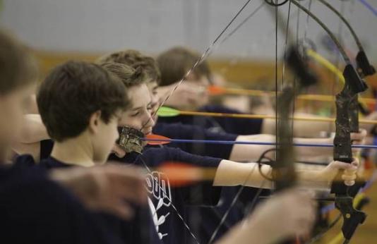 student archers taking aim during archery practice