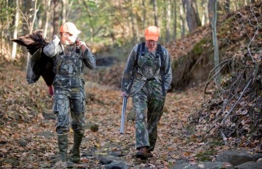 two turkey hunters walking in woods