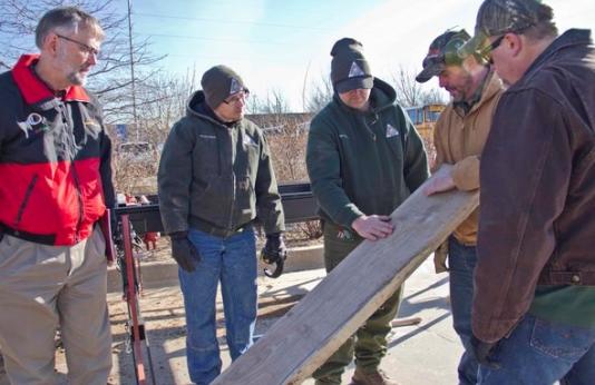 group at lumber workshop